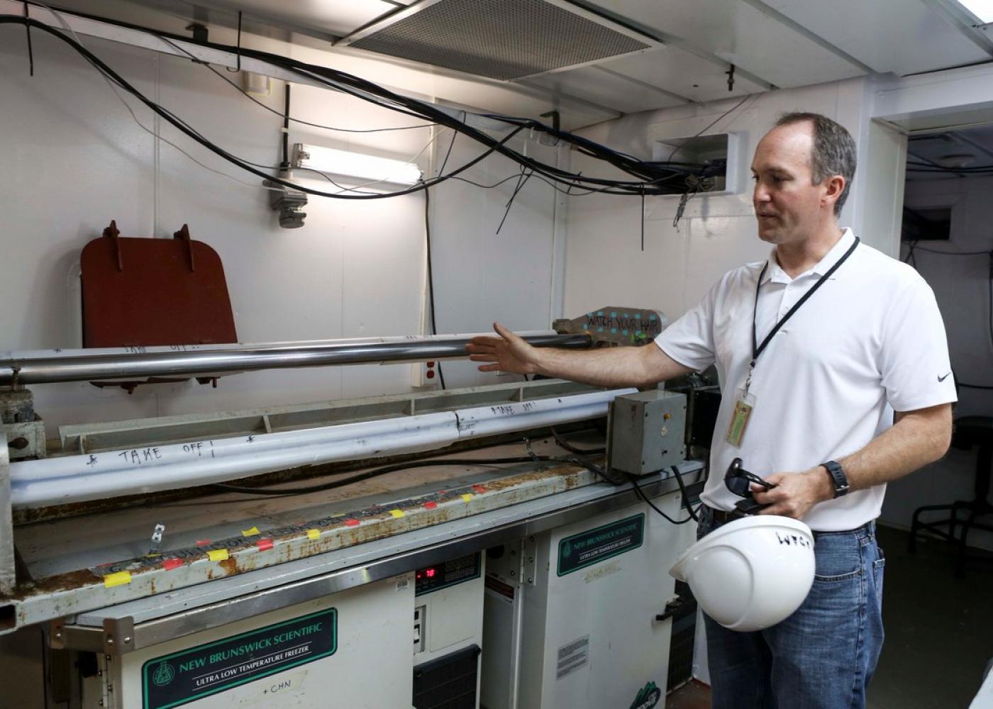 Adam MacDonald, NS Department of Energy & Mines, examines a core sample taken during an offshore coring cruise