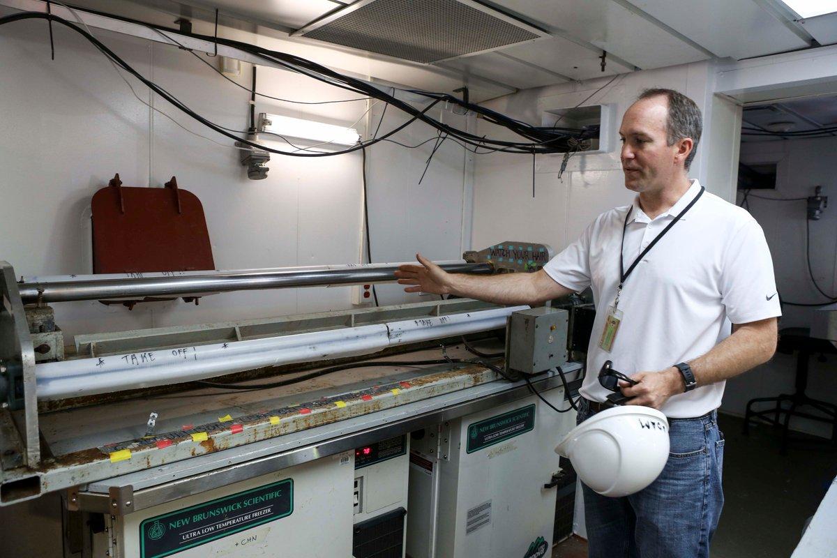 Adam MacDonald, NS Department of Energy & Mines, examines a core sample taken during an offshore coring cruise